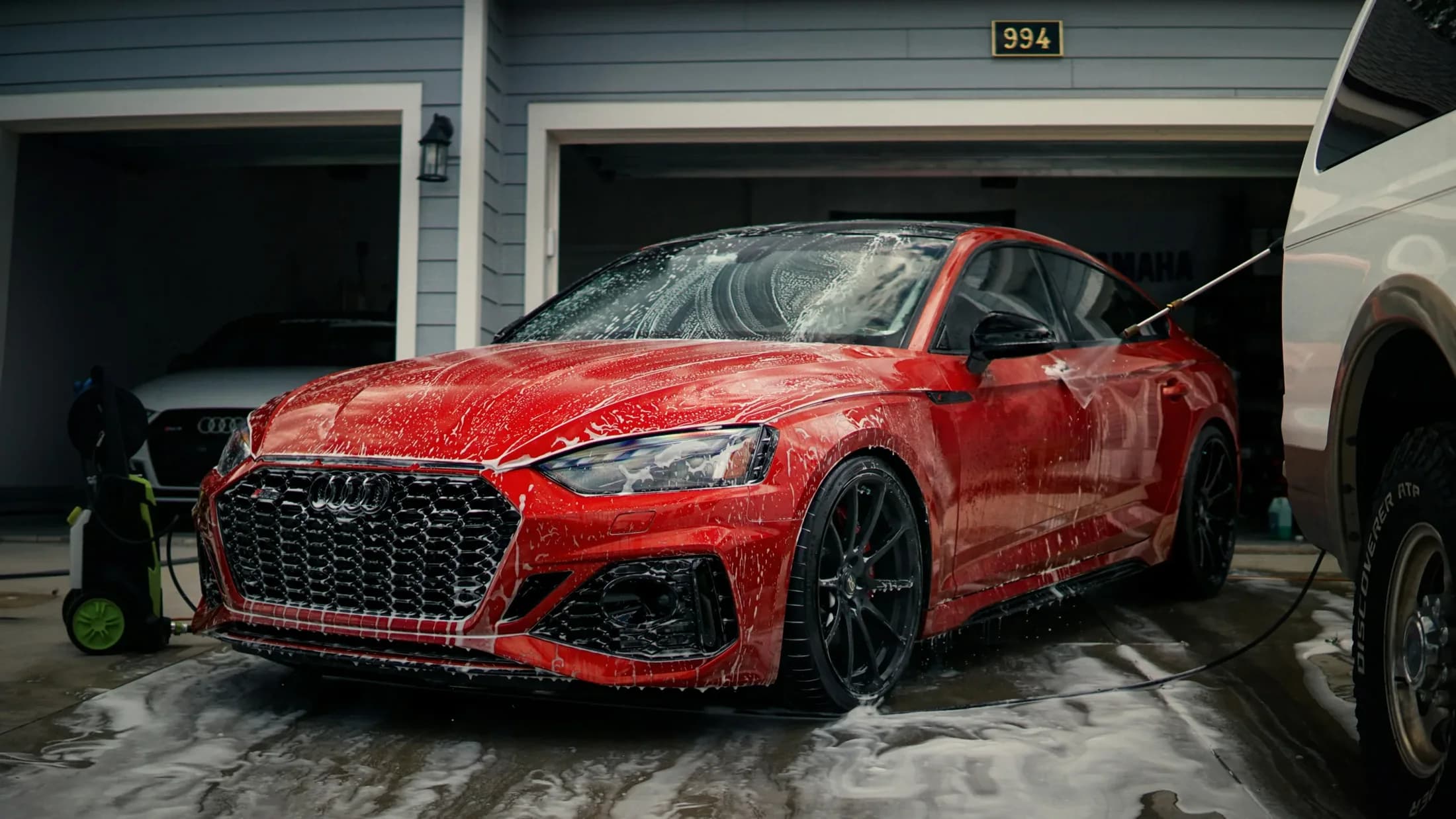 Red vehicle being washed by Advantage Mobile Detailing